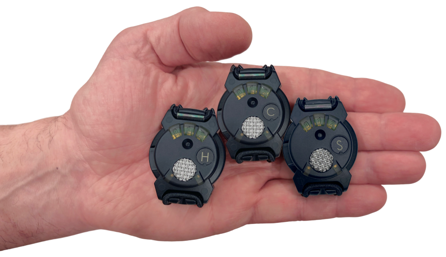 Hand holding three Blast Gauge sensors in open palm
